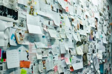 A chaotic bulletin board overflowing with a multitude of papers notes and  photographs symbolizing a hive of activity and overflowing creativity |  Premium AI-generated image